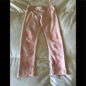 Pink leggings with sewn in designs